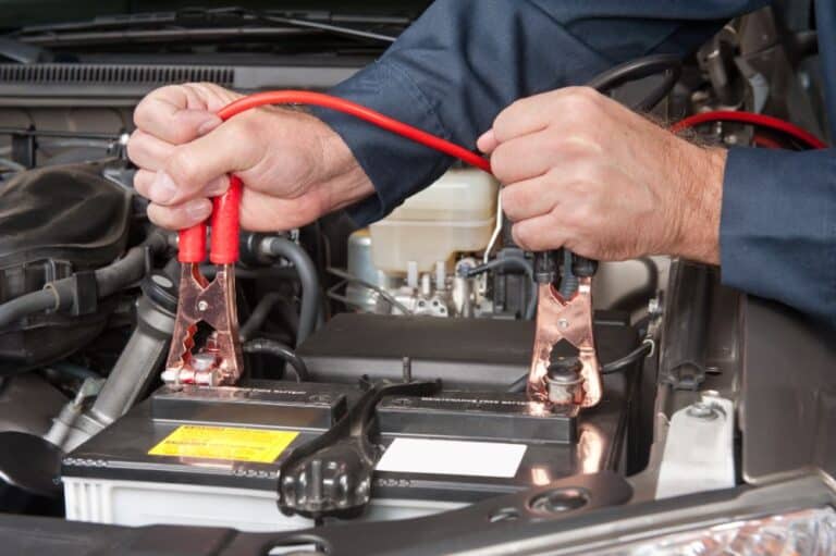 car battery being charged by a mechanic