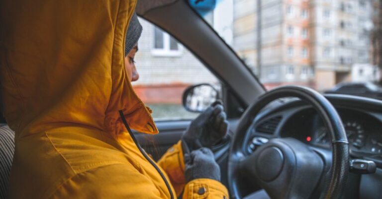 Woman in a winter jacket driving her car