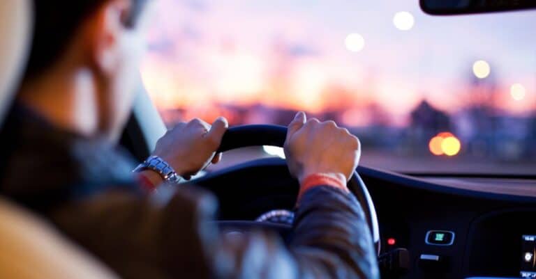 Man holding his steering wheel driving