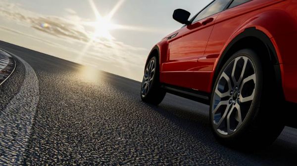 Car on the road towards the sun