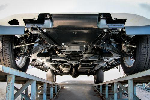 Car up on ramps for suspension inspection